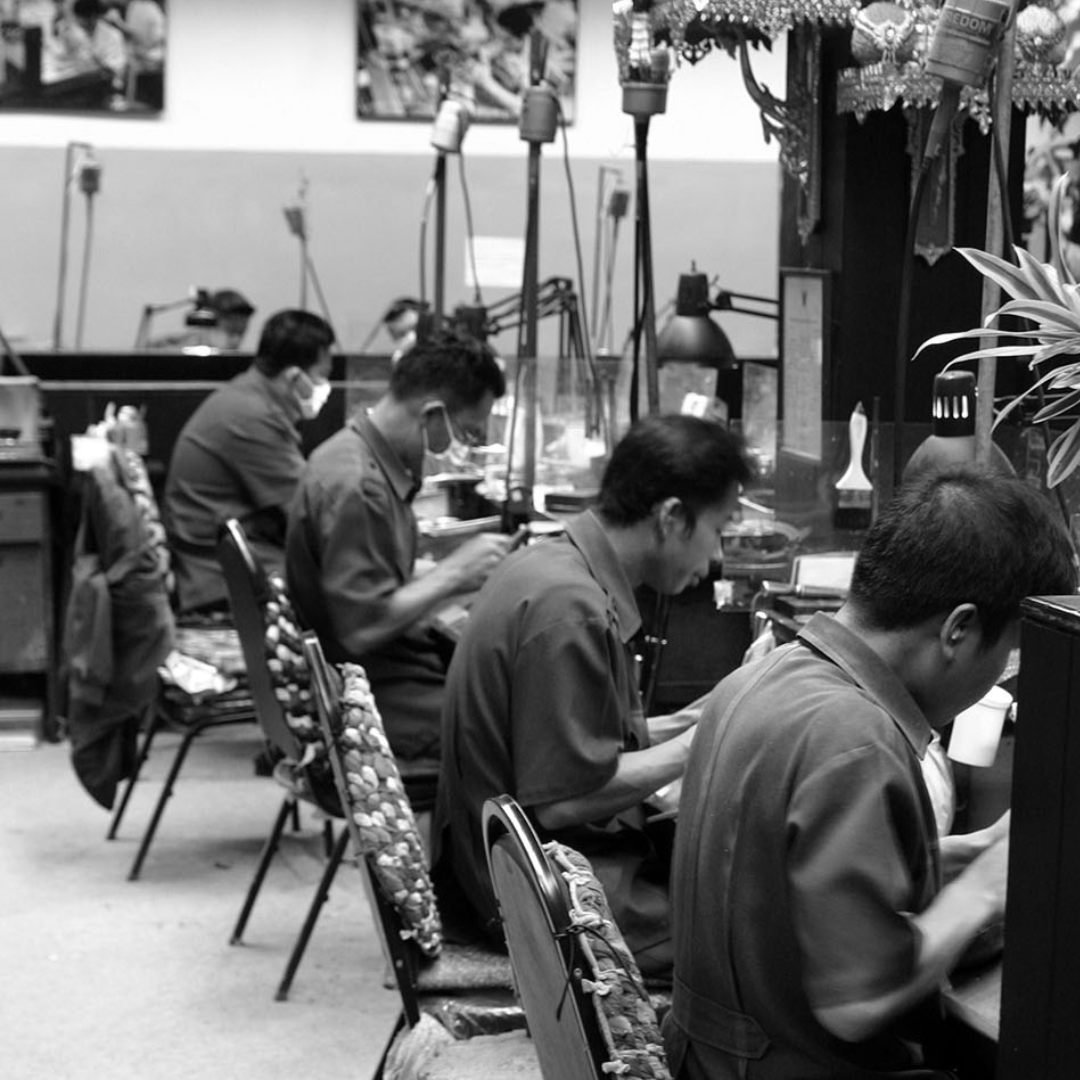Gold makers sitting together crafting gold
