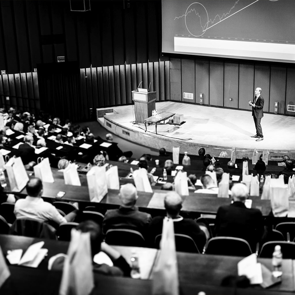 Speaker talking on stage in front of audience