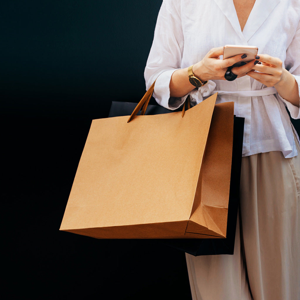 Lady standing holding handbag